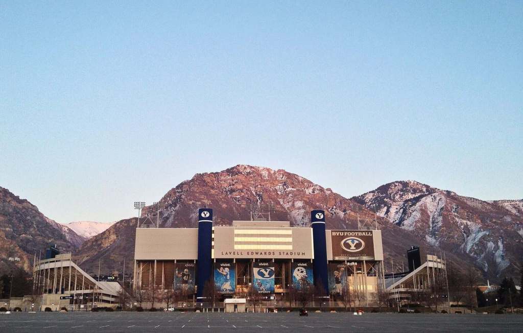 Exterior view of LaVell Edwards Stadium with mountain backdrop.